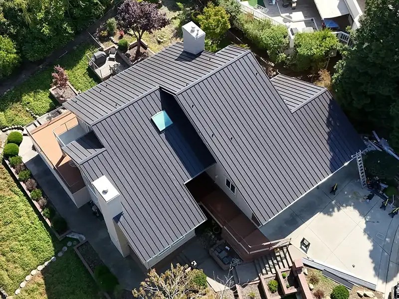 Home with new dark bronze standing seam metal roof