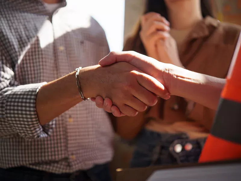 Contractor shaking hands with client